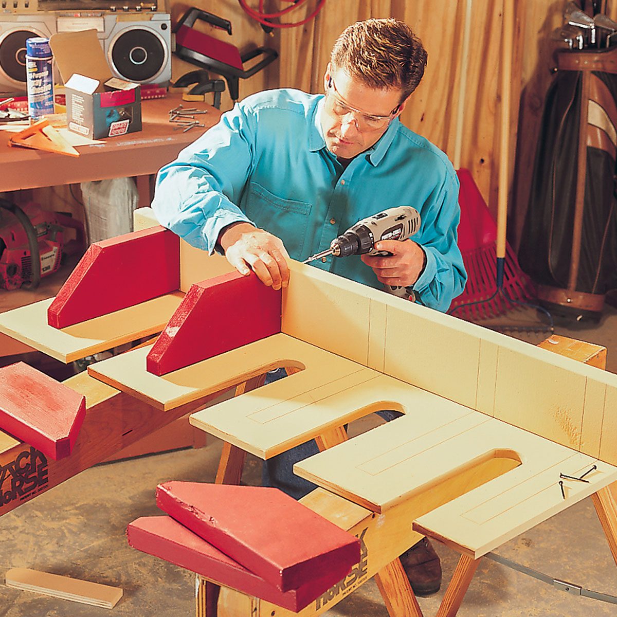 A Man Fastens Screws into Rack with Drill
