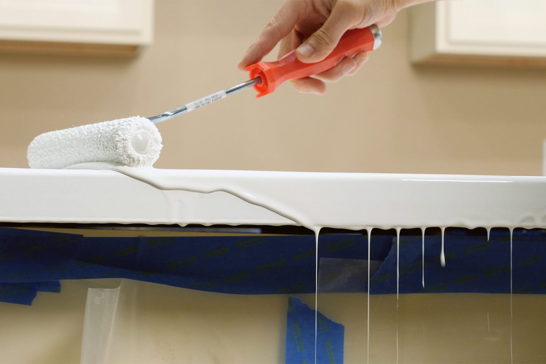 Applying white paint with paint roller