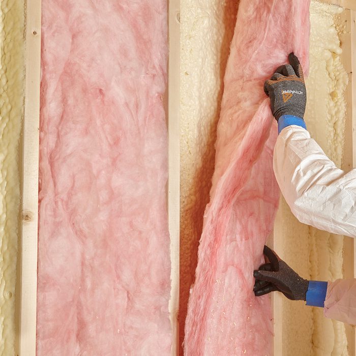 Laying fiberglass over spray foam | Construction Pro Tips