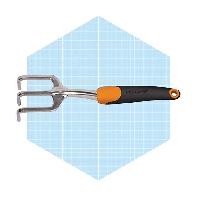 A three-pronged garden cultivator with a metal head and an ergonomic orange and black handle is displayed on a light blue grid background.