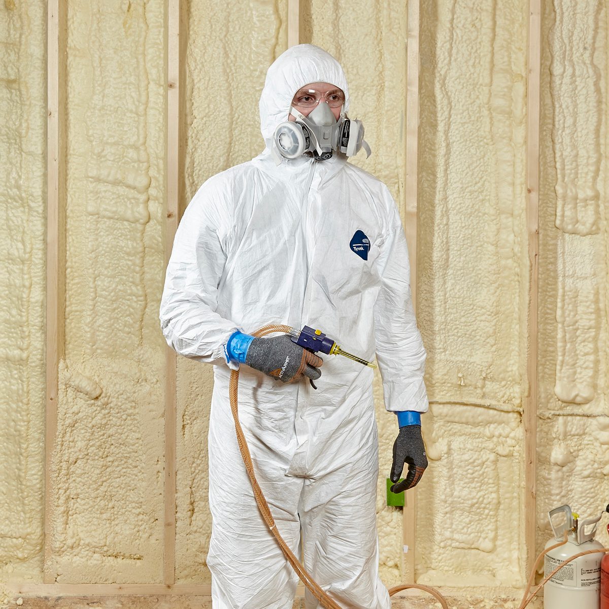 Man wearing proper spray-foaming gear | Construction Pro Tips