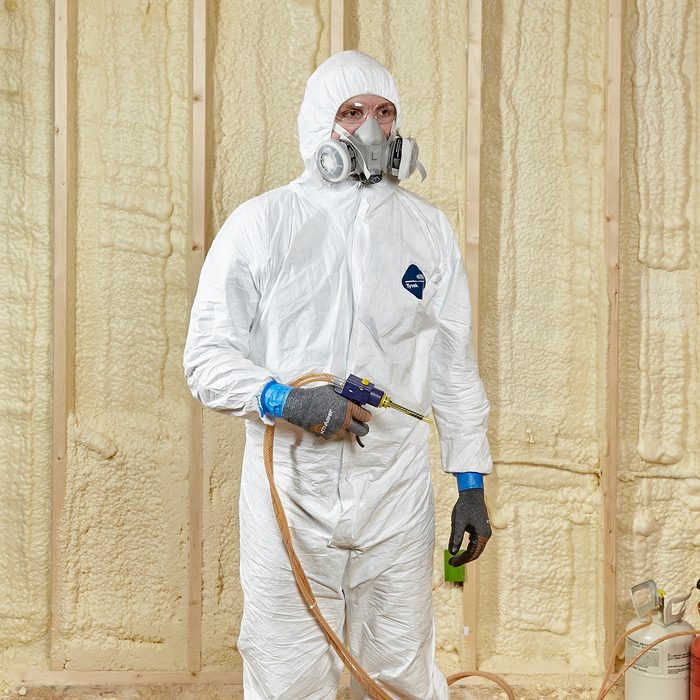 Man wearing proper spray-foaming gear | Construction Pro Tips