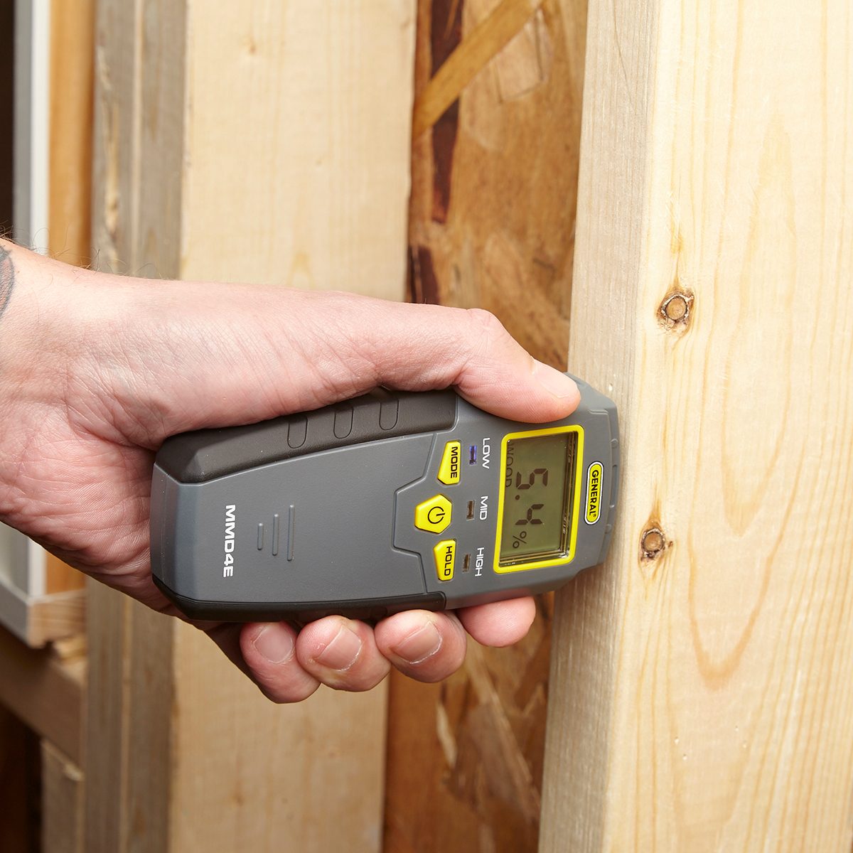 Poking wood with a moisture meter | Construction Pro Tips