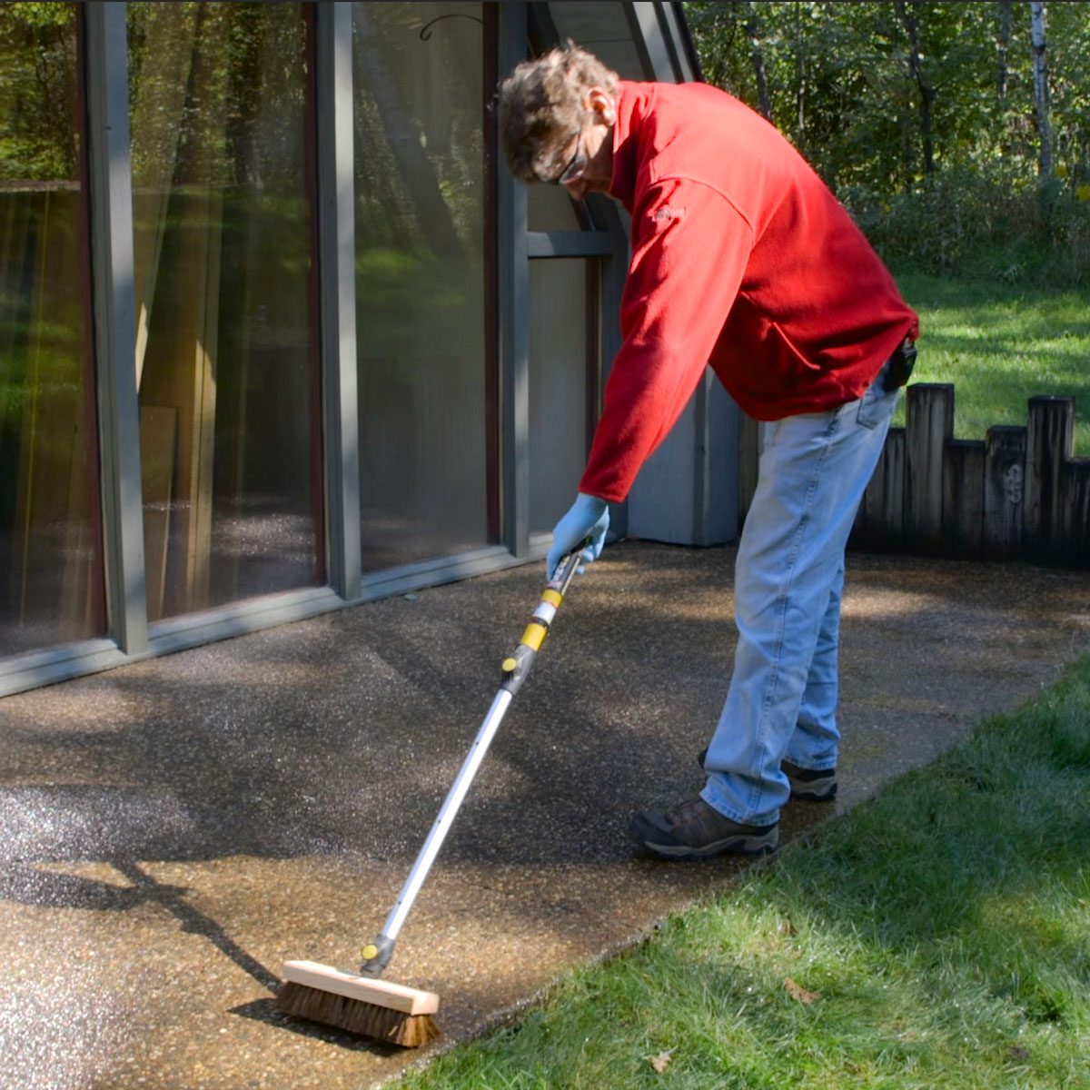 scrubbing concrete with stiff brush