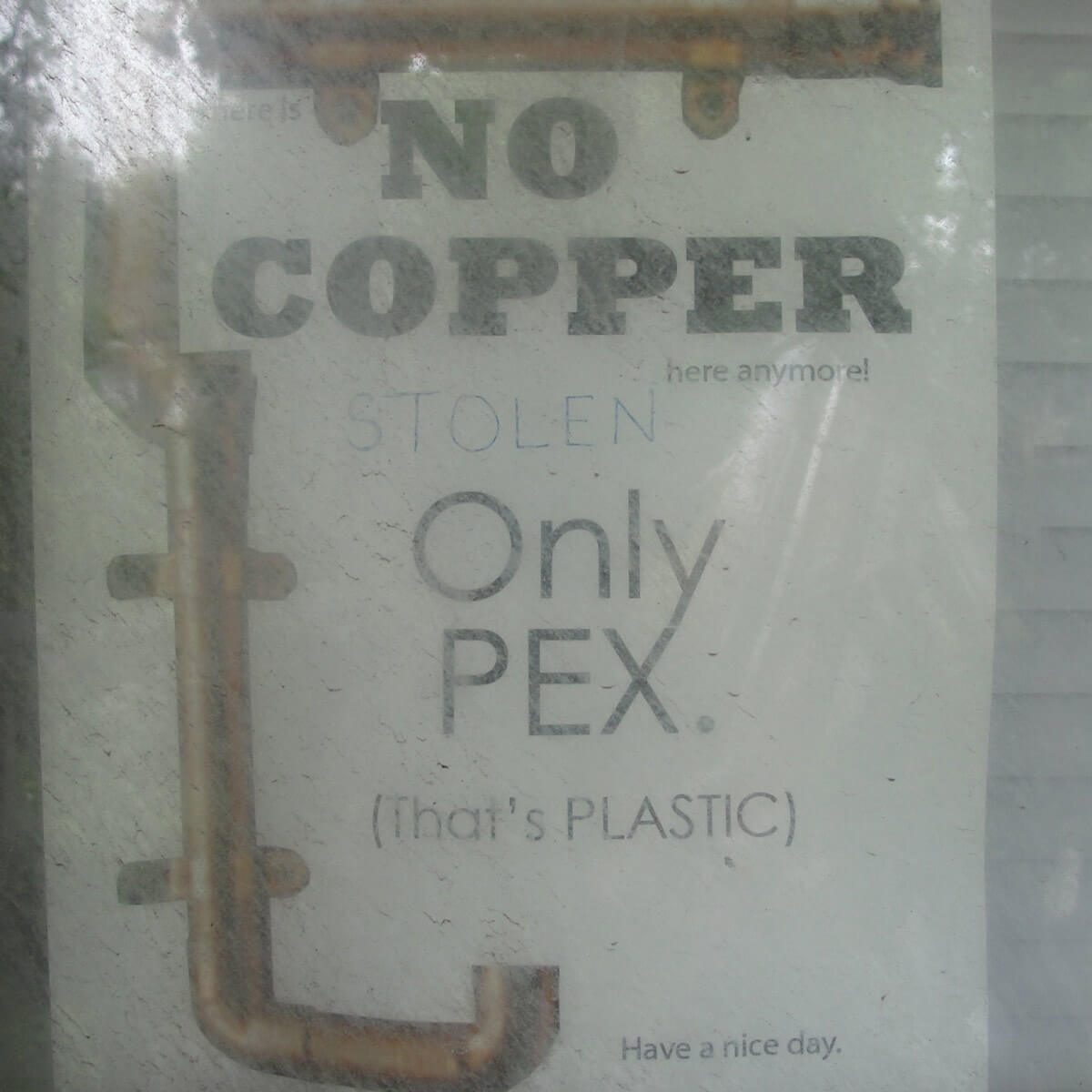 A sign displays a message discouraging theft of copper, emphasizing the use of PEX plastic pipes instead, set against a light background.