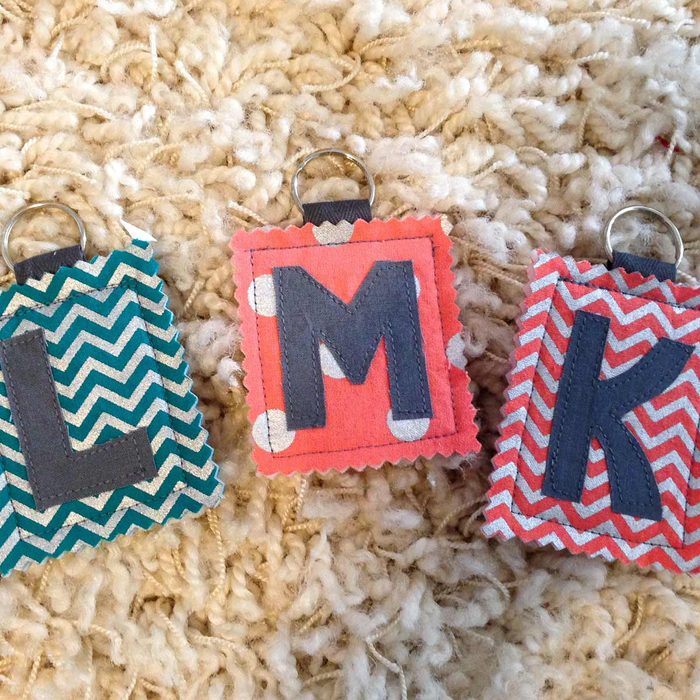 Three colorful fabric tags with letters 