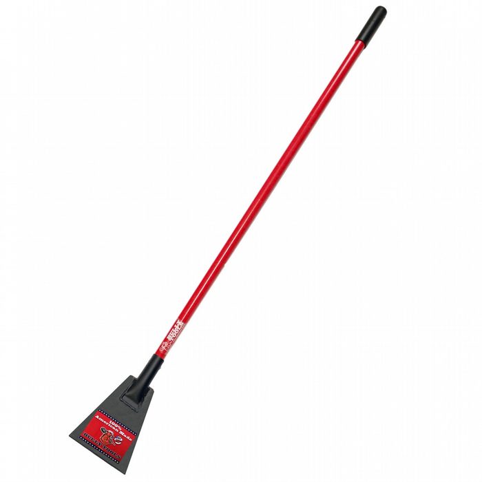 A red-handled scraper tool stands upright, its triangular metal blade poised for scraping surfaces, likely in a garage or outdoor setting.