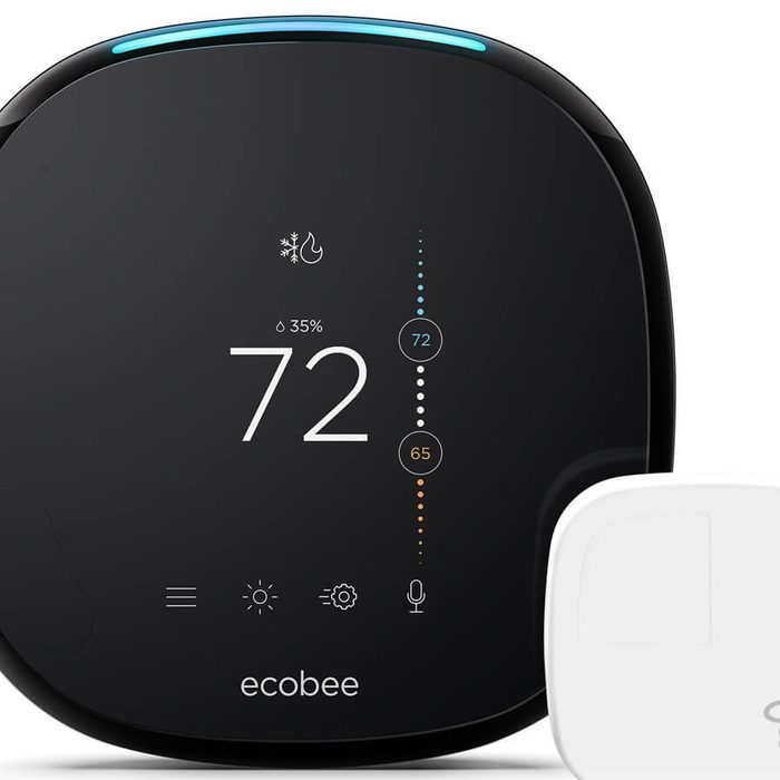 A black smart thermostat displays a temperature of 72°F, alongside a white sensor. It shows icons for humidity and climate control settings.