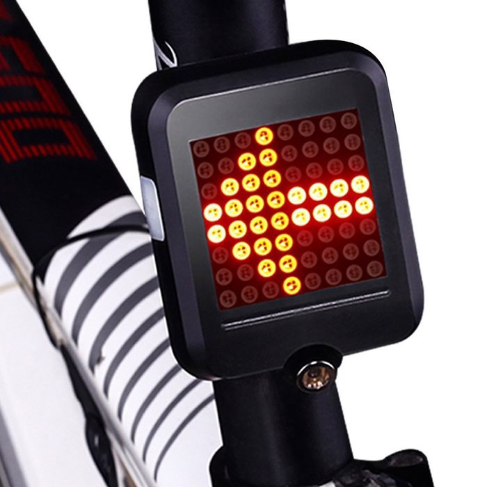 A rectangular bike signal light displays an illuminated arrow, indicating direction. It