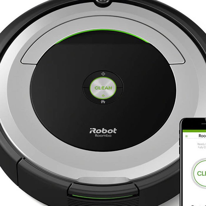 A robotic vacuum cleaner navigates a flat surface, indicated by a green 
