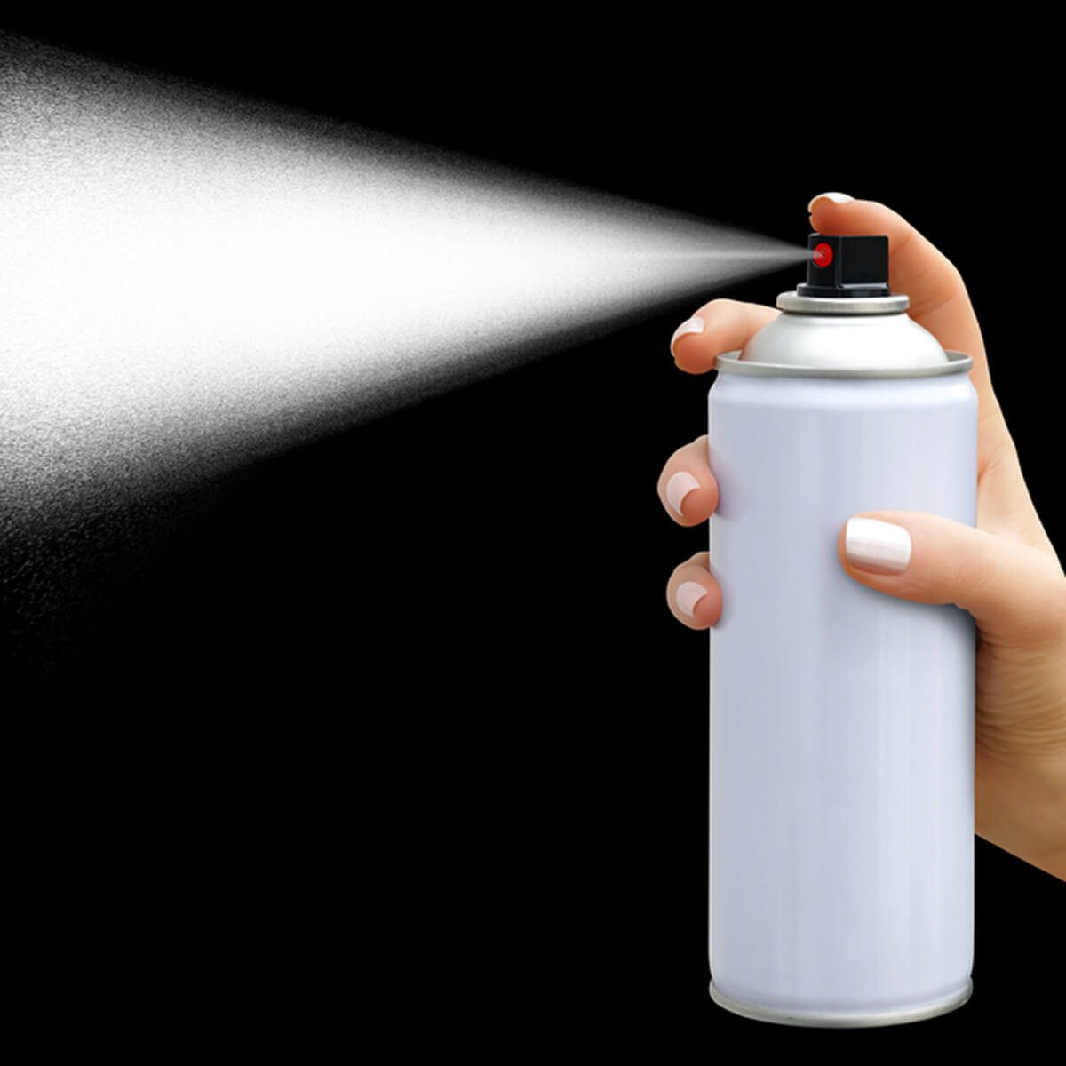 A hand holds a white spray can, releasing a fine mist into a dark background, indicating a spraying action in a controlled environment.