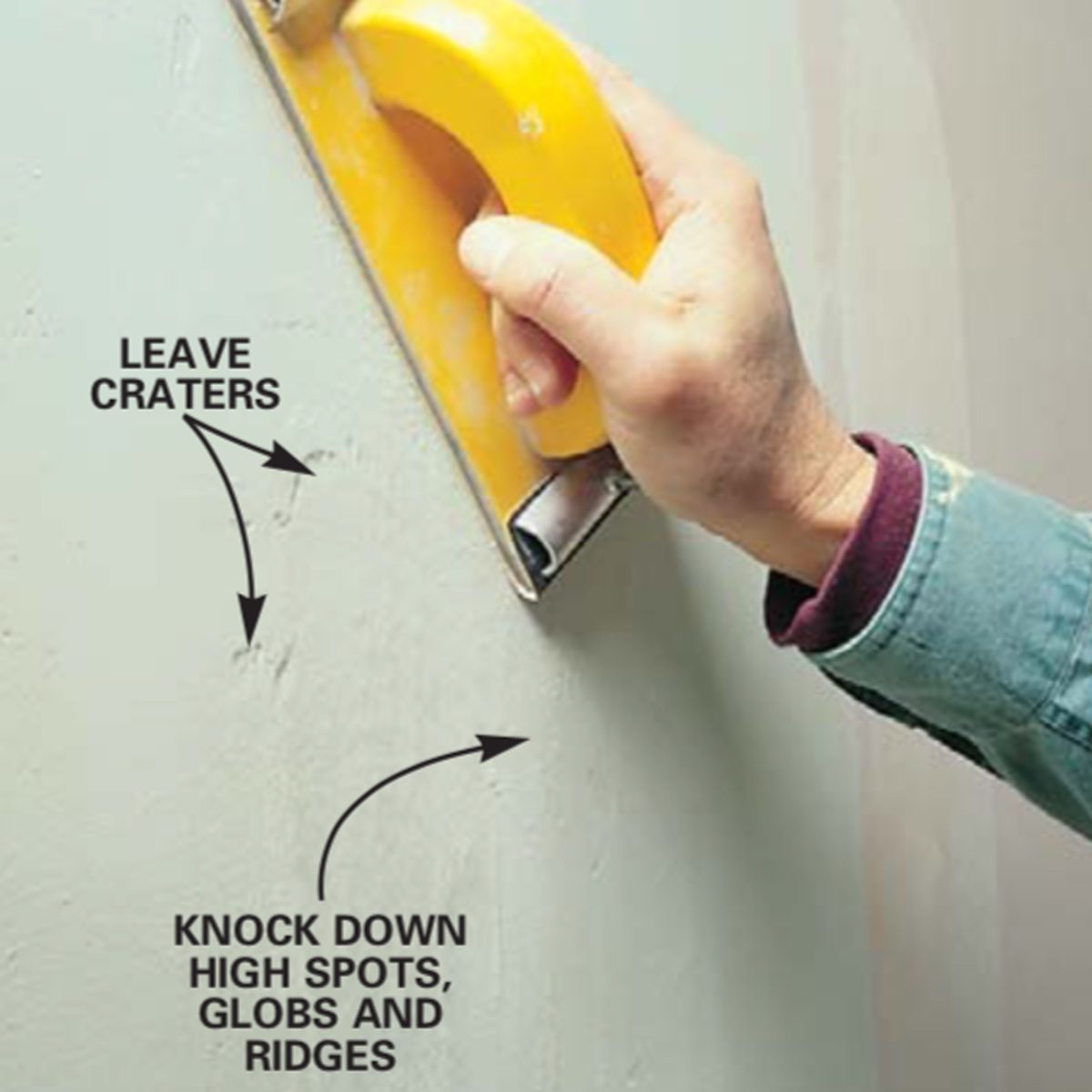 A hand holds a yellow scraper against a wall, smoothing its surface while text indicates to leave craters and knock down high spots.