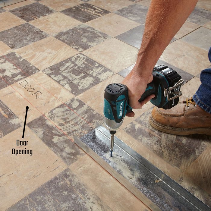 Laying track up to the door opening | Construction Pro Tips