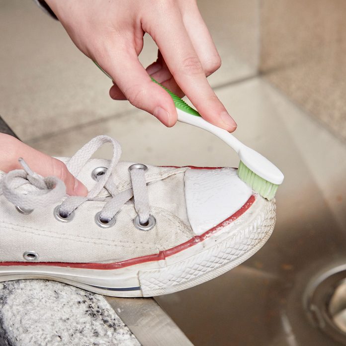 HH clean sneakers with a toothbrush and toothpaste white