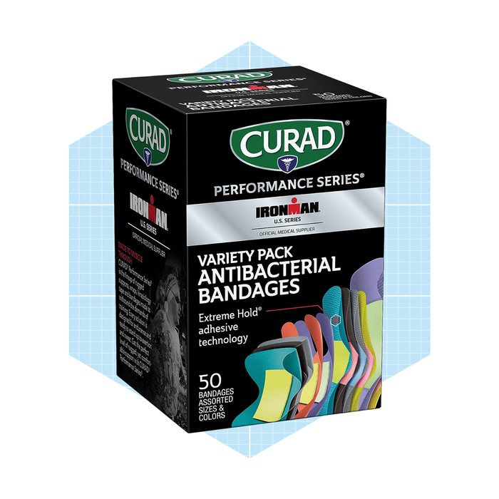 A black box containing assorted antibacterial bandages is displayed. The box indicates it includes 50 pieces in various sizes and colors, promoting extreme hold technology.