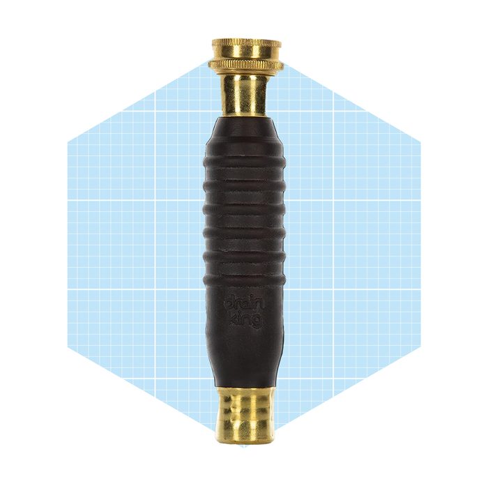 A black rubber handle with brass fittings is positioned vertically against a light blue grid background, suggesting it