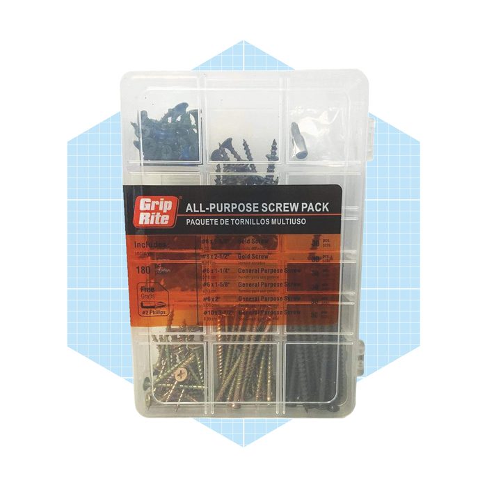 A clear plastic container holds various screws, organized by type and size, labeled for easy identification. It rests on a light blue patterned background.