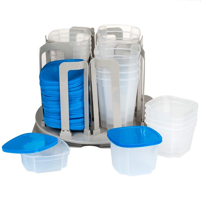 A rotating storage organizer holds transparent and blue plastic food containers, providing easy accessibility in a tidy, compact arrangement on a light background.