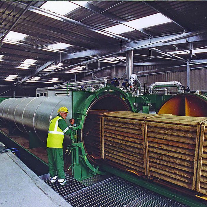 Man using pressure to create treated wood | Construction Pro Tips