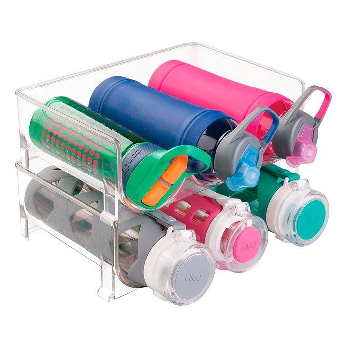 A clear container holds various colorful water bottles, some upright and others on their sides, organized neatly for easy access.