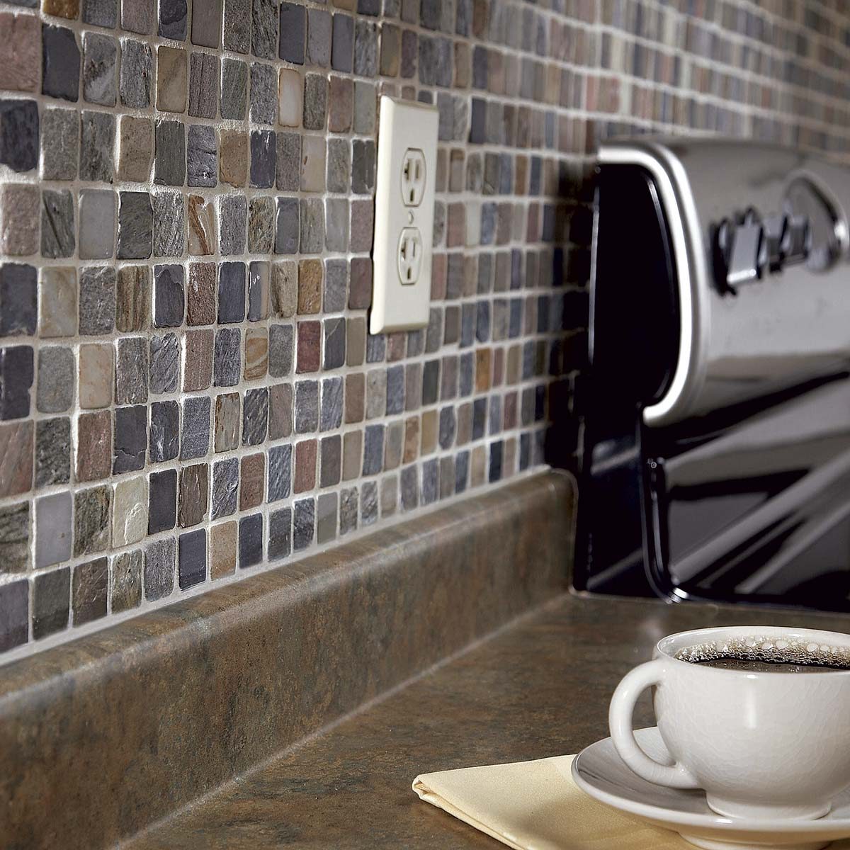 close up of a mosaic backsplash above a kitchen counter