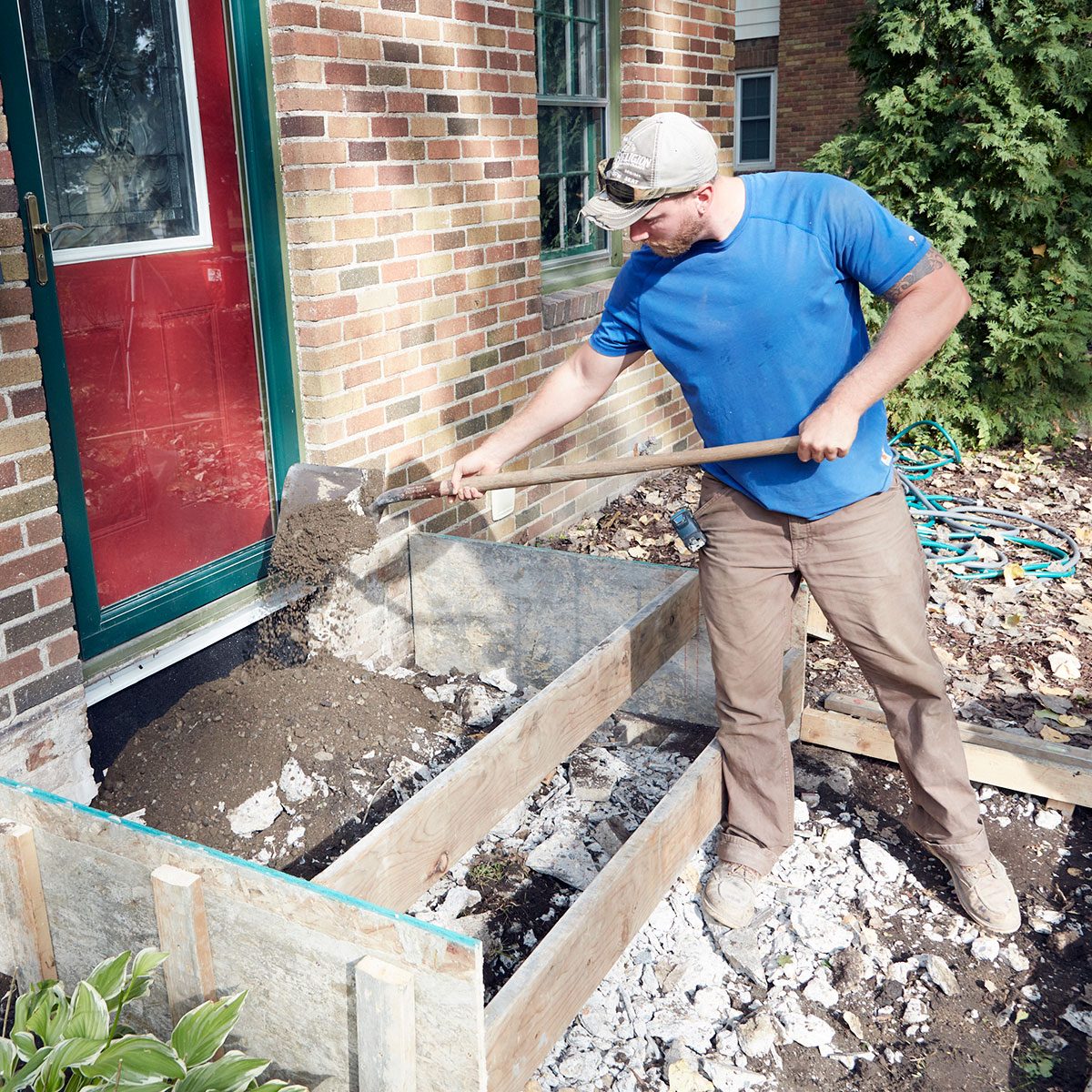 Man adding fill inside the forms for concrete steps | Construction Pro Tips