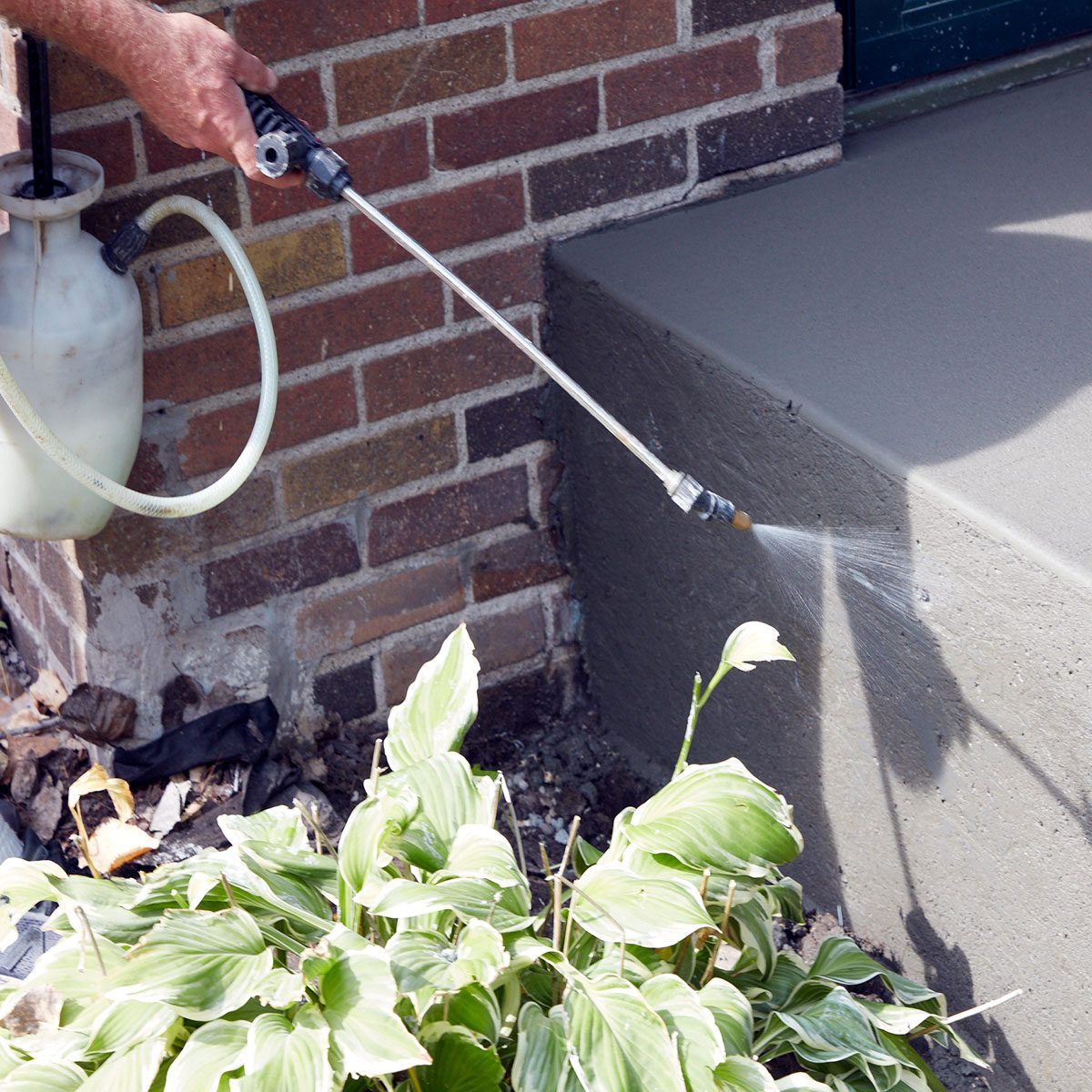 Spraying evaporation retardent onto the poured steps | Construction Pro Tips