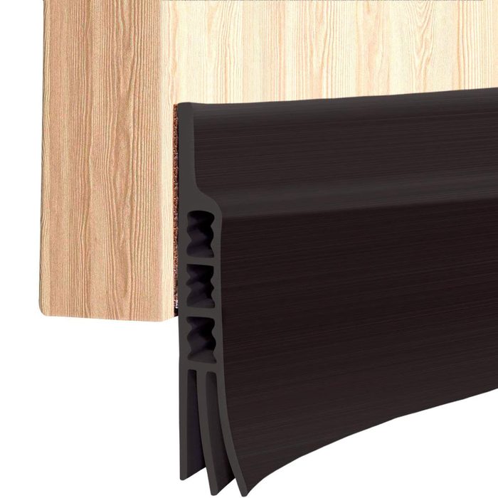 A black molding piece is positioned next to a wood-textured panel, showcasing its profile and design features against a light backdrop.