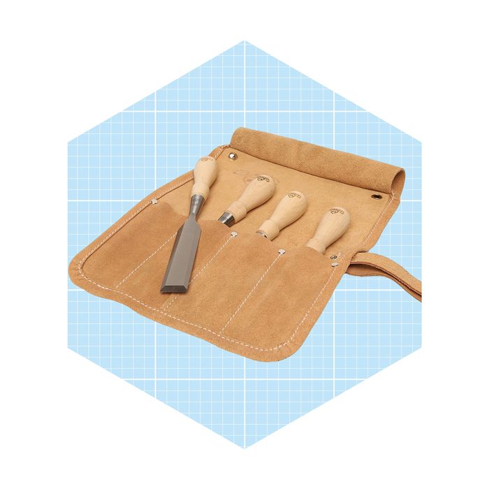 A leather tool roll contains four wooden-handled chisels, elegantly arranged for use, set against a light blue grid background.