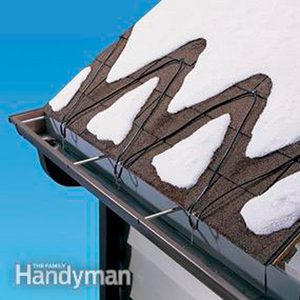 A roof is equipped with heating cables, melting snow into pointed shapes above brown shingles, set against a blue backdrop.