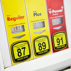 Three fuel dispensers display prices per gallon for Shell Regular ($1.999), Plus ($2.199), and V-Power ($2.339) with octane ratings.