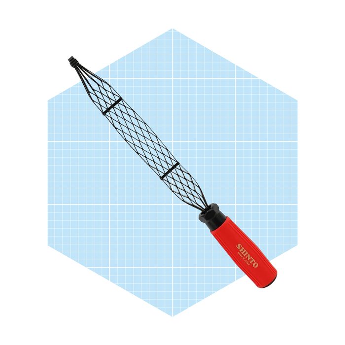A red-handled scoop net is positioned diagonally on a light blue grid background, designed for catching small aquatic creatures.