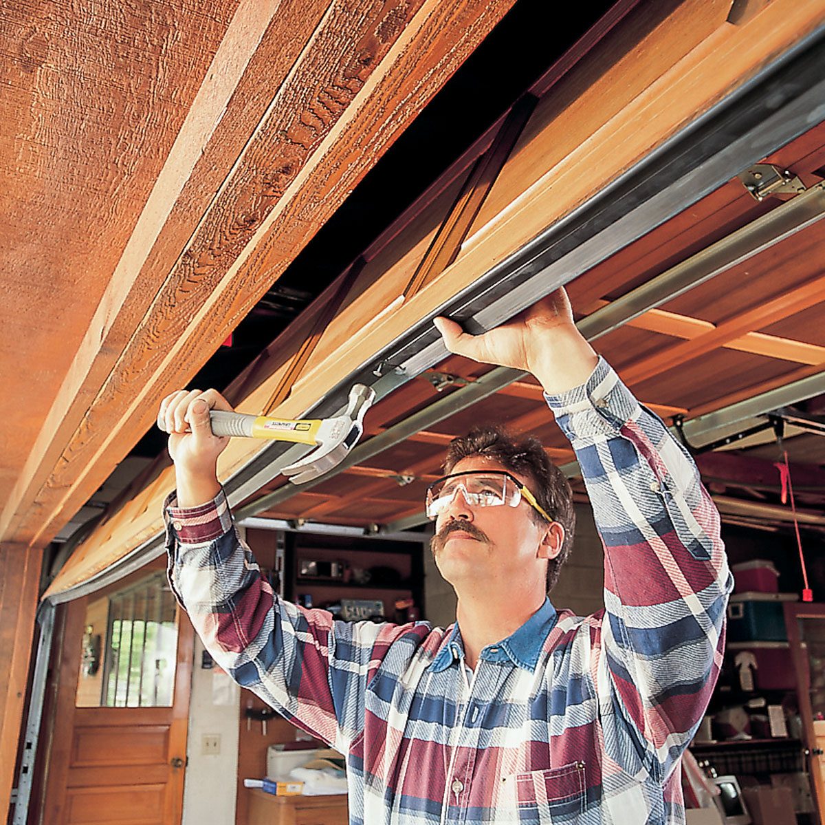 Hammering a nail into Garage door's bottom