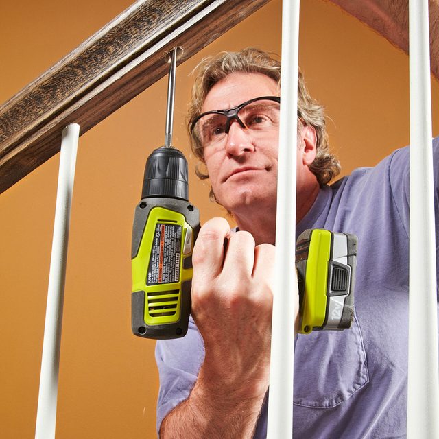 Man Deepening the upper hole with hand driller