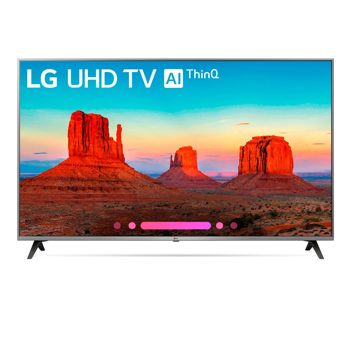 A television displays a vibrant desert landscape with red rock formations under a blue and orange sky, showcasing the natural beauty of the scene.