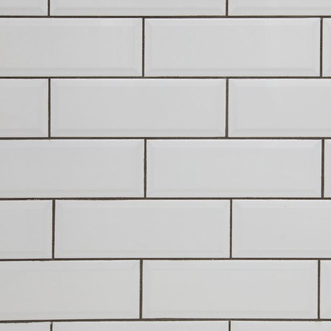 White subway tile wall and dark grout for a kitchen or bathroom backsplash