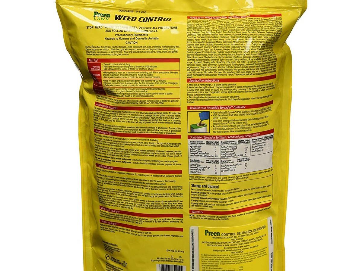 A yellow bag of weed control product is displayed, featuring instructions and safety information prominently on its back, in a clean, indoor setting.