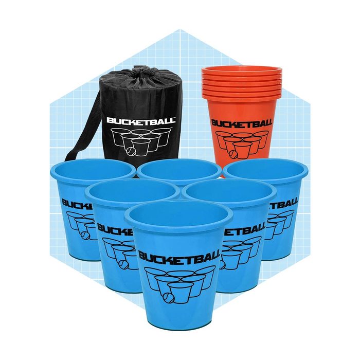 Blue and red plastic cups are arranged for a game, alongside a black bag labeled 