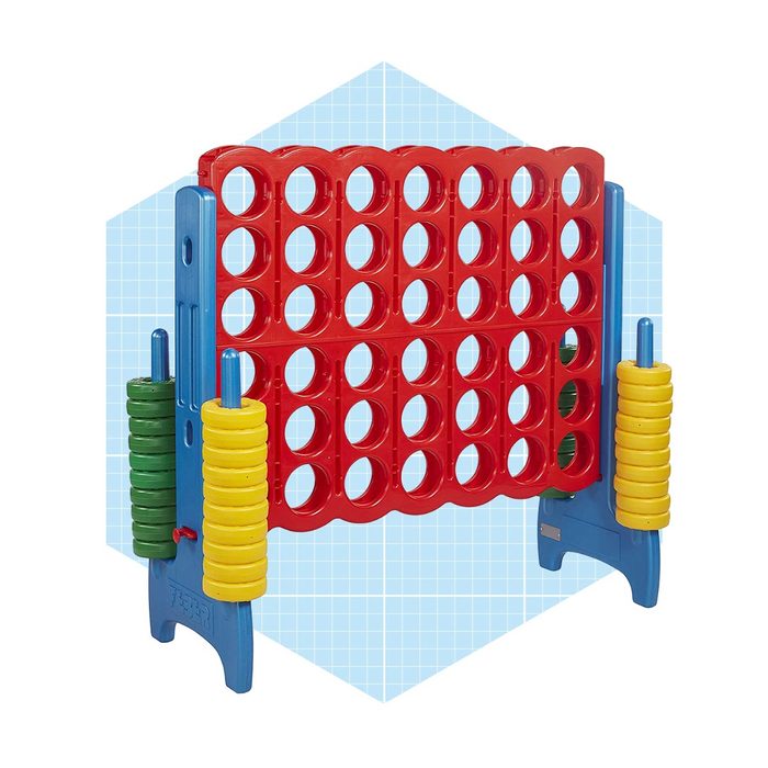 A large, upright connect-four game displays red and yellow discs placed in a grid, set against a light blue geometric background.