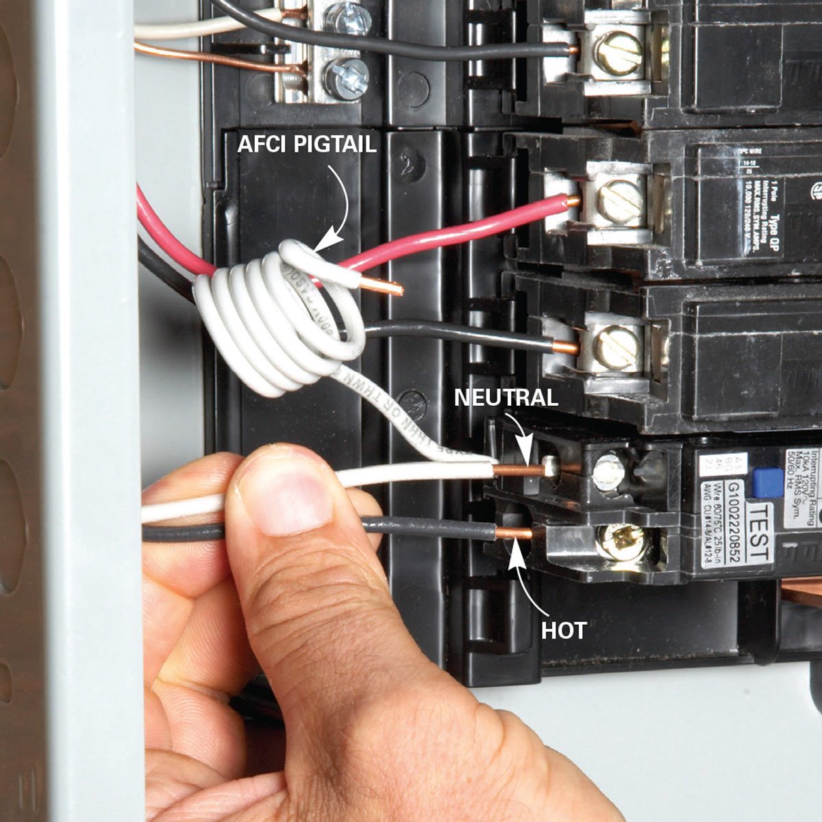 A hand connects electrical wires labeled "NEUTRAL" and "HOT" inside a circuit breaker panel, surrounded by additional wires and components.