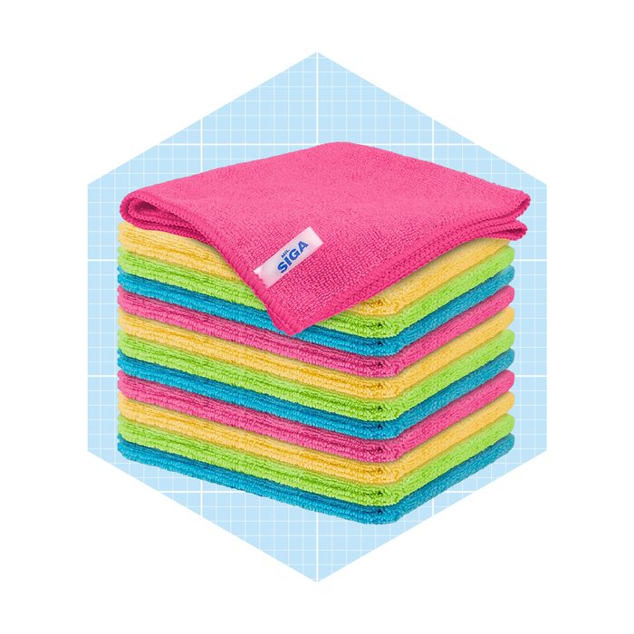A stack of brightly colored microfiber cloths is neatly arranged, with a pink cloth on top, set against a light blue grid background.
