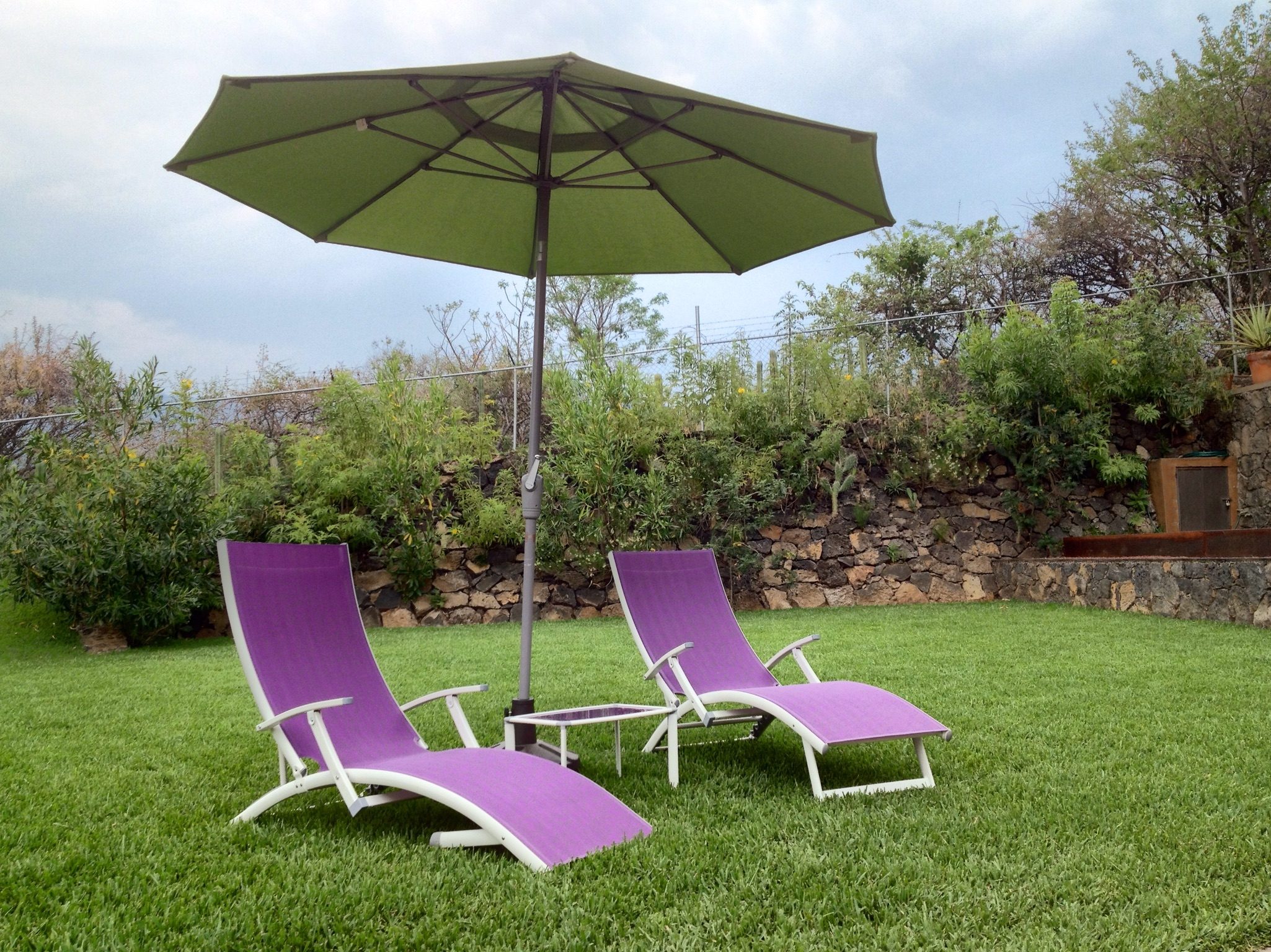 Patio Umbrella With Lounge Chair In Field