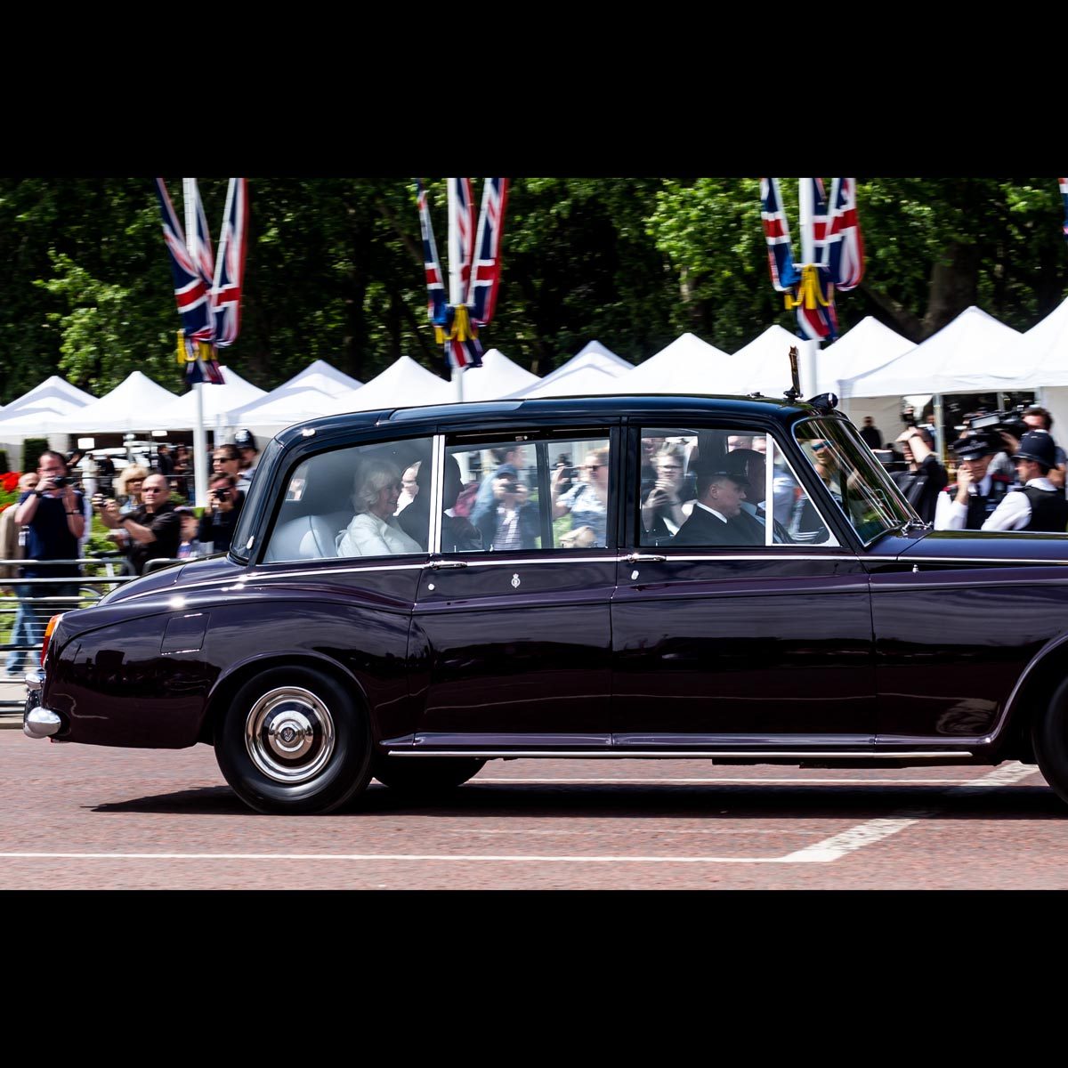 Camilla and Charles head back along the Mall to Clarence House after attending a reception at Buckingham Palace to welcome President Trump