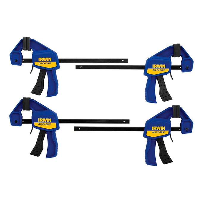 Two blue and yellow quick-grip clamps are displayed, each with a trigger for adjustment, resting on a flat surface surrounded by a neutral background.