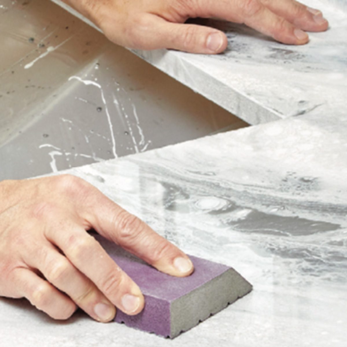 smoothing the top of epoxy countertop