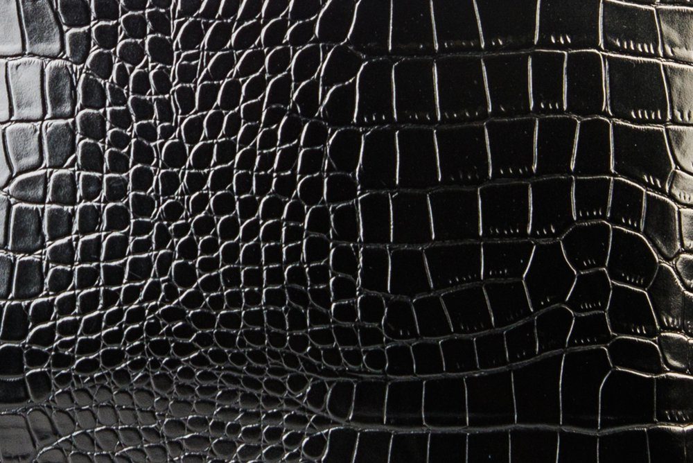 The texture of the leather in black. Patent leather