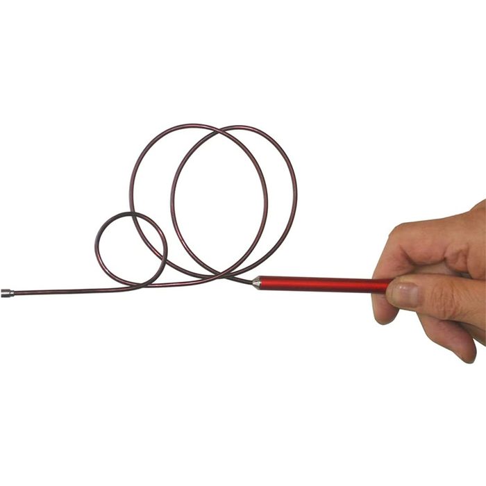 A hand holds a red handle attached to a coiled metal wire, demonstrating its flexibility and allowing manipulation in an open, blank space.