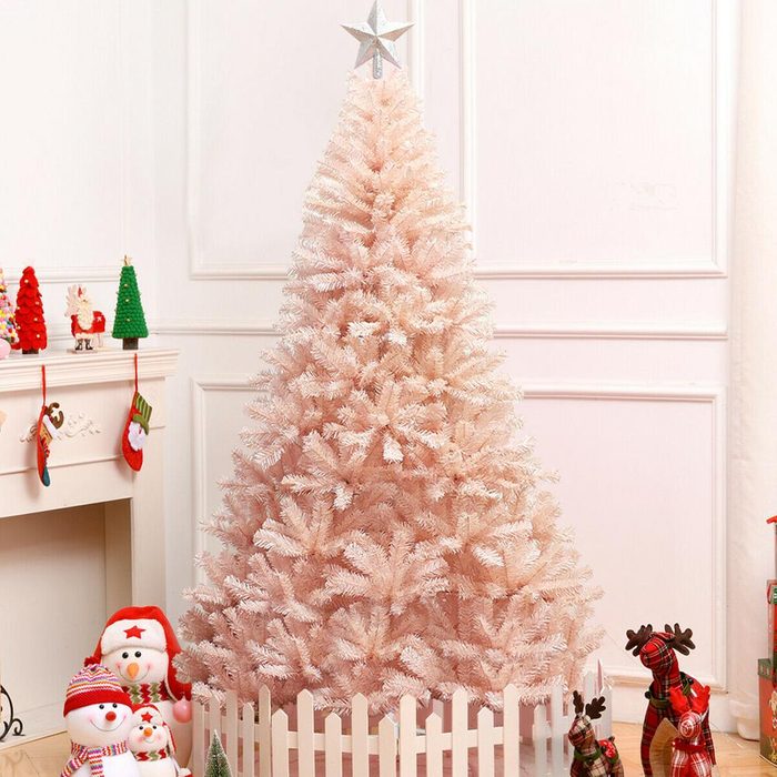 A pink artificial Christmas tree adorned with a star stands in a cozy room, surrounded by festive decorations and plush toys.