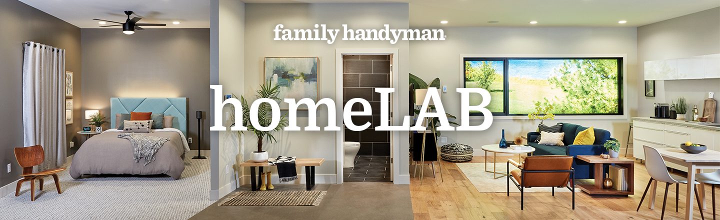 A modern bedroom and living area showcase stylish furniture. A large window frames greenery outside, while cozy decor enhances the inviting atmosphere.