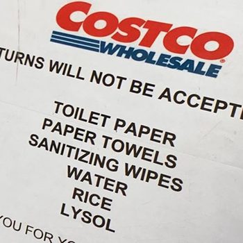 A notice lists items like toilet paper and sanitizing wipes, indicating they cannot be returned. The context is a retail environment, likely Costco.